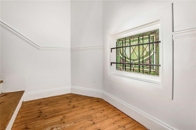 spare room with hardwood / wood-style flooring and plenty of natural light