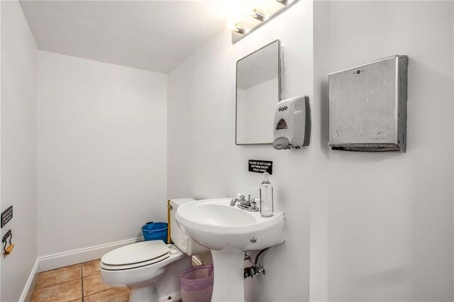 bathroom with toilet and tile patterned floors