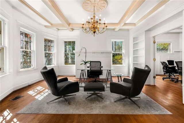 living area featuring an inviting chandelier, hardwood / wood-style floors, and a wealth of natural light