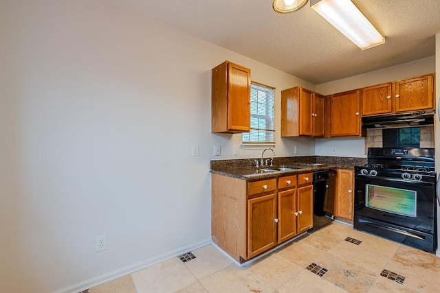 kitchen with visible vents, brown cabinets, black appliances, under cabinet range hood, and a sink