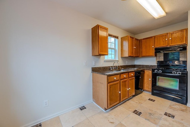 kitchen featuring visible vents, a sink, black appliances, under cabinet range hood, and brown cabinets