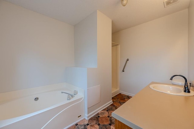 bathroom featuring visible vents, walk in shower, baseboards, a bath, and vanity