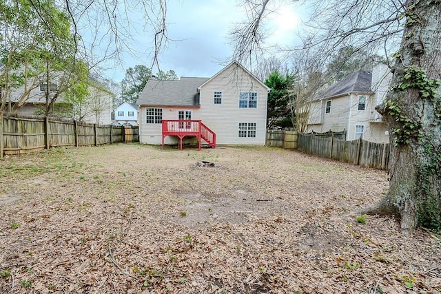 back of property with crawl space, a fenced backyard, roof with shingles, and a wooden deck