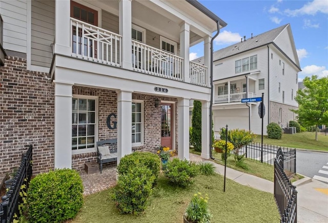 exterior space featuring brick siding and a balcony