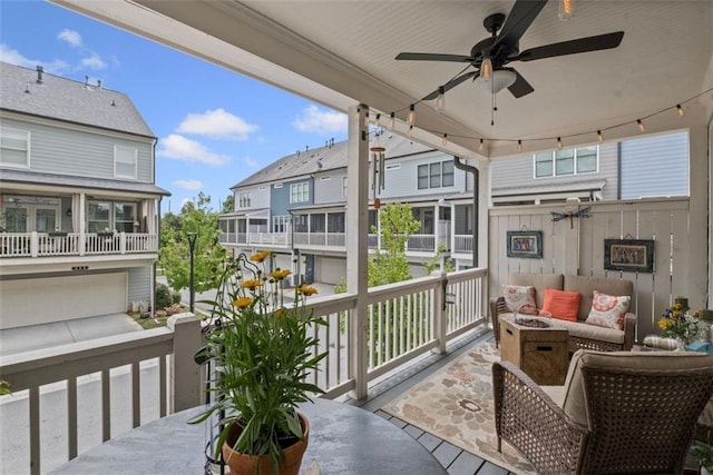 balcony featuring ceiling fan, a residential view, and an outdoor hangout area
