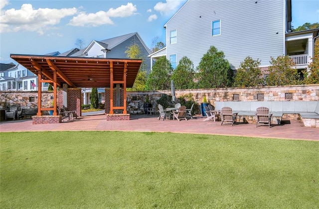 surrounding community featuring a lawn and a patio area