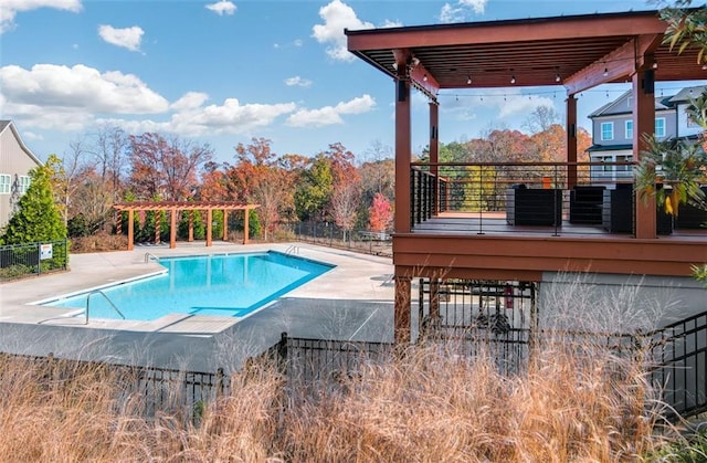 community pool with fence, a pergola, and a patio area