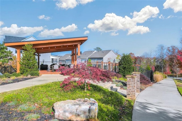 view of home's community featuring fence