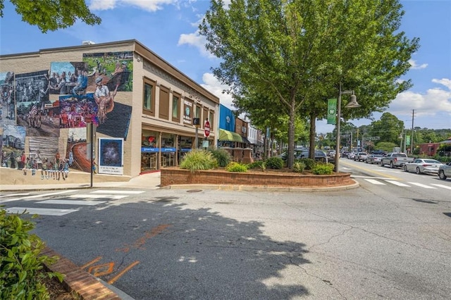 view of road with curbs, street lights, and sidewalks