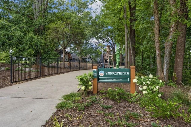 view of home's community featuring fence