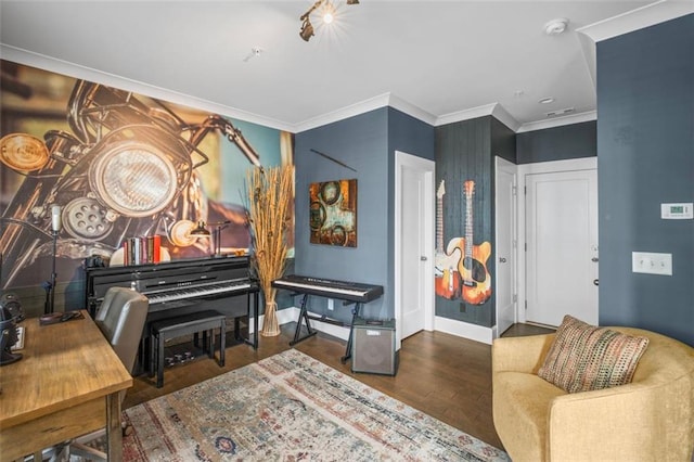 sitting room featuring baseboards, ornamental molding, and wood finished floors