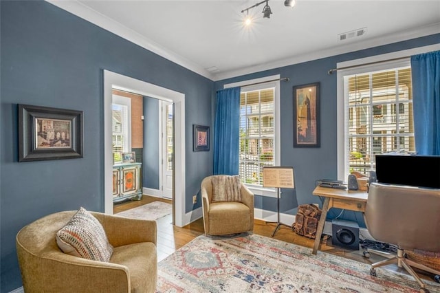 office area with visible vents, rail lighting, wood finished floors, baseboards, and ornamental molding