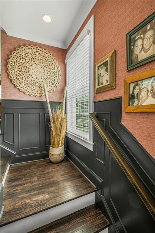 stairs with a wainscoted wall, baseboards, recessed lighting, and wood finished floors