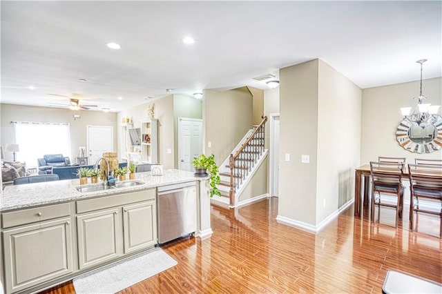3068 Cedar Glade Ln, Buford, GA 30519 - kitchen featuring sink, decorative light fixtures, stainless steel dishwasher, light hardwood / wood-style floors, and ceiling fan with notable chandelier