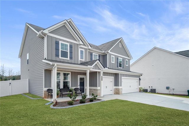 craftsman house featuring a front lawn, a porch, and a garage