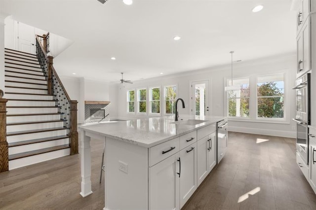 1005 Coleman Place Dr, Roswell, GA 30075 - kitchen featuring stainless steel dishwasher, wood finished floors, white cabinetry, a ceiling fan, and recessed lighting