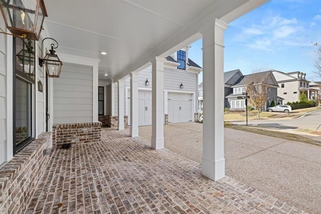 1005 Coleman Place Dr, Roswell, GA 30075 - covered porch with an attached garage, driveway, and a residential view