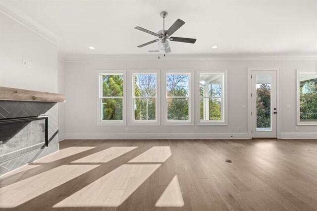 1005 Coleman Place Dr, Roswell, GA 30075 - unfurnished living room with crown molding, a glass covered fireplace, ceiling fan, wood finished floors, and recessed lighting