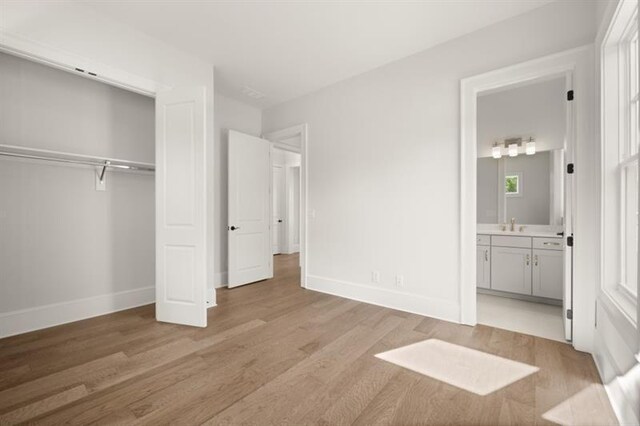 1005 Coleman Place Dr, Roswell, GA 30075 - unfurnished bedroom with light wood-style flooring, a closet, and connected bathroom