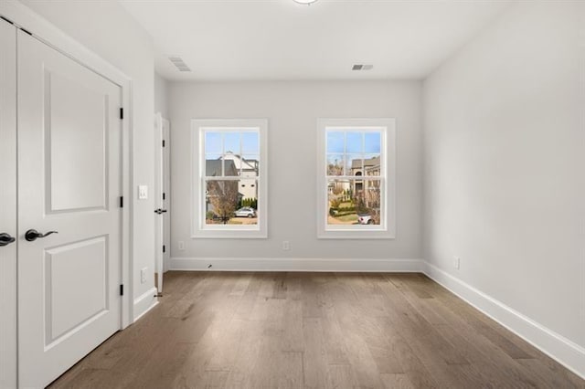 1005 Coleman Place Dr, Roswell, GA 30075 - unfurnished bedroom with wood finished floors and a closet