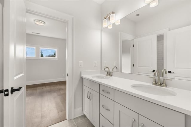 1005 Coleman Place Dr, Roswell, GA 30075 - bathroom featuring double vanity and baseboards