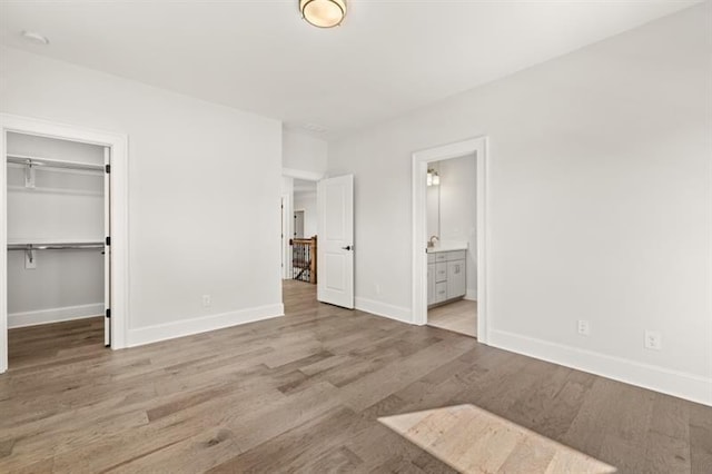 1005 Coleman Place Dr, Roswell, GA 30075 - unfurnished bedroom with wood finished floors, a spacious closet, a closet, and ensuite bathroom