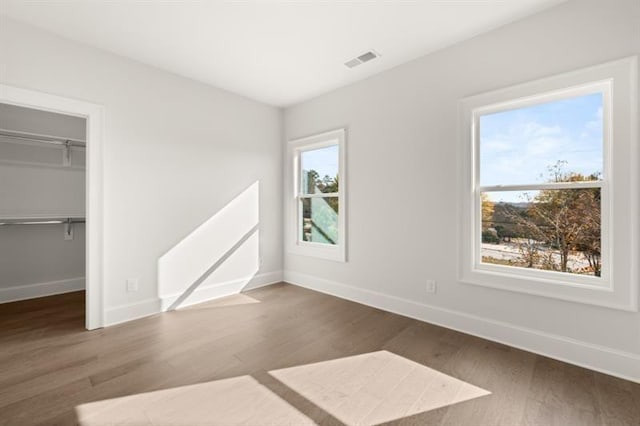 1005 Coleman Place Dr, Roswell, GA 30075 - unfurnished bedroom with wood finished floors, a walk in closet, and a closet