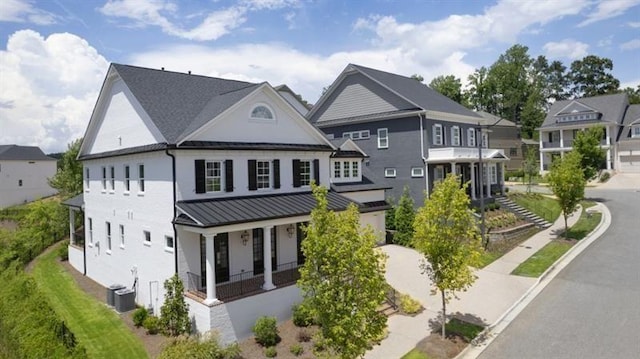 1005 Coleman Place Dr, Roswell, GA 30075 - view of front facade with a standing seam roof, covered porch, a metal roof, stucco siding, and a garage