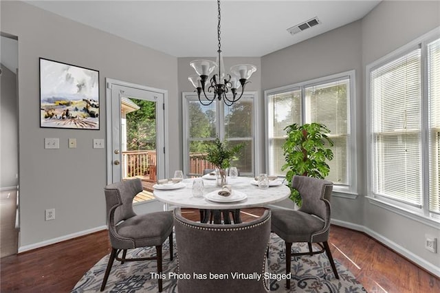 dining room with plenty of natural light and dark hardwood / wood-style floors