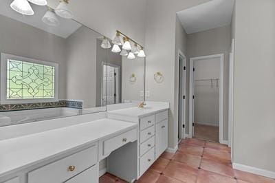 bathroom with vanity, tile patterned flooring, and a tub