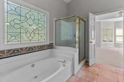 bathroom with shower with separate bathtub and tile patterned floors