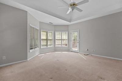 spare room with light colored carpet and ceiling fan