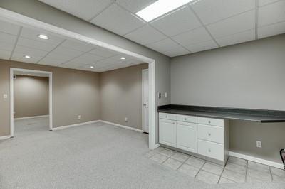 unfurnished office with a paneled ceiling and light colored carpet