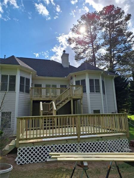 rear view of property with a wooden deck