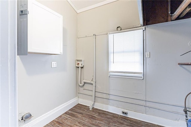 washroom with laundry area, crown molding, baseboards, and dark wood-type flooring