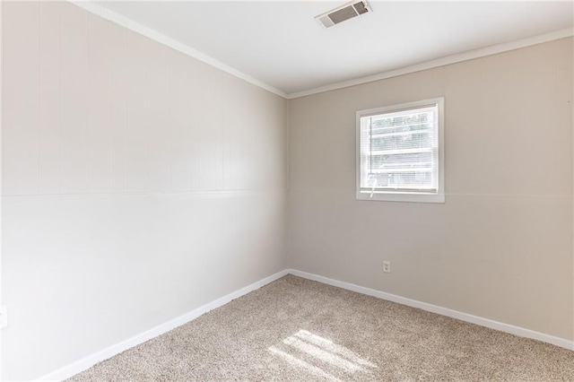 spare room featuring baseboards, visible vents, crown molding, and carpet flooring