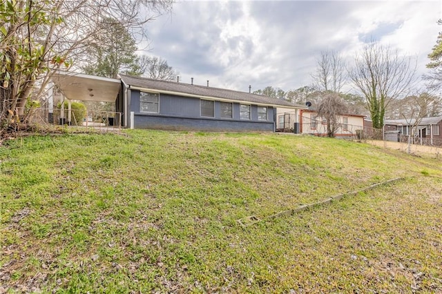 back of property with a yard and fence