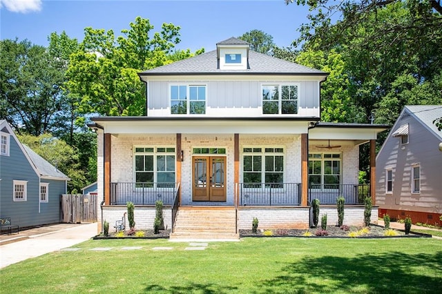 view of front of home featuring covered porch and a front lawn