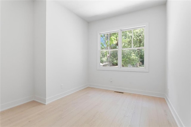 unfurnished room with light hardwood / wood-style flooring