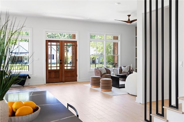 foyer entrance with hardwood / wood-style flooring, a wealth of natural light, french doors, and ceiling fan