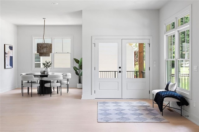 foyer entrance with light wood-type flooring and french doors