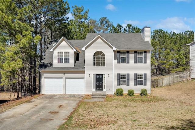 colonial inspired home with a garage, entry steps, concrete driveway, a chimney, and fence