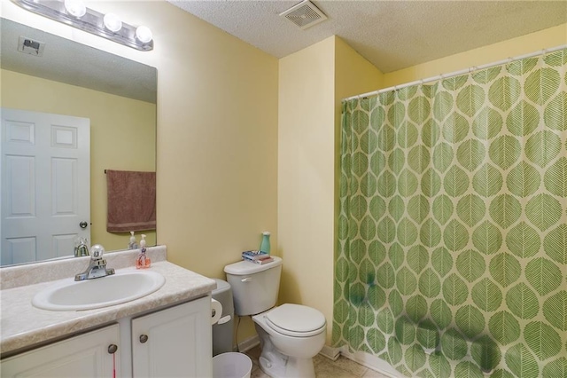 full bath featuring visible vents, vanity, toilet, and a textured ceiling