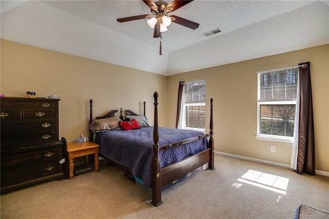 bedroom featuring light colored carpet, visible vents, vaulted ceiling, and multiple windows