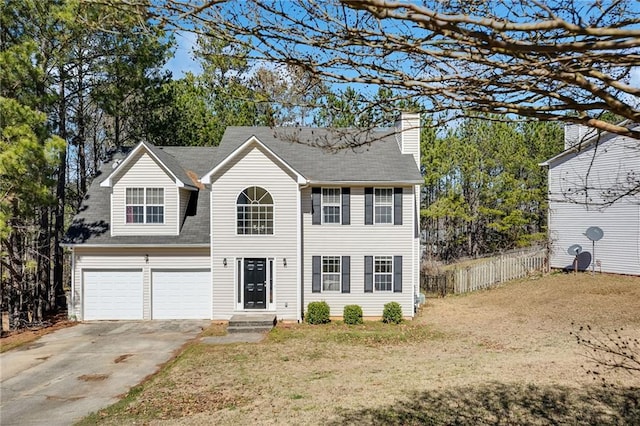 colonial-style house featuring a chimney, concrete driveway, fence, a garage, and a front lawn