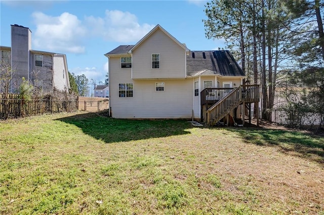 rear view of property featuring stairs, a yard, fence, and a wooden deck