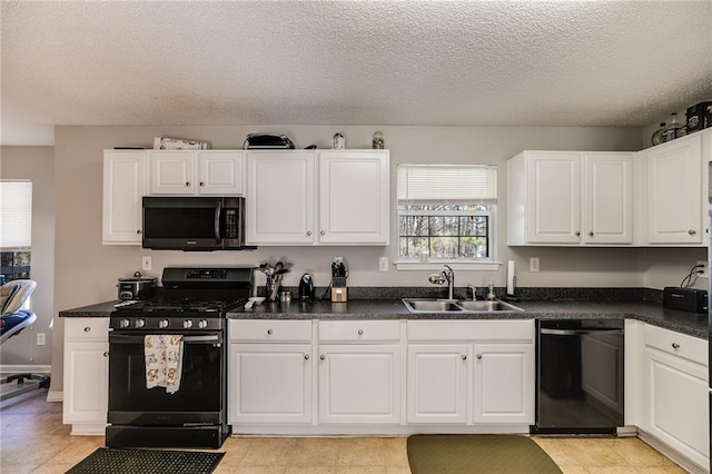 kitchen with stainless steel gas range oven, dishwasher, dark countertops, white cabinetry, and a sink