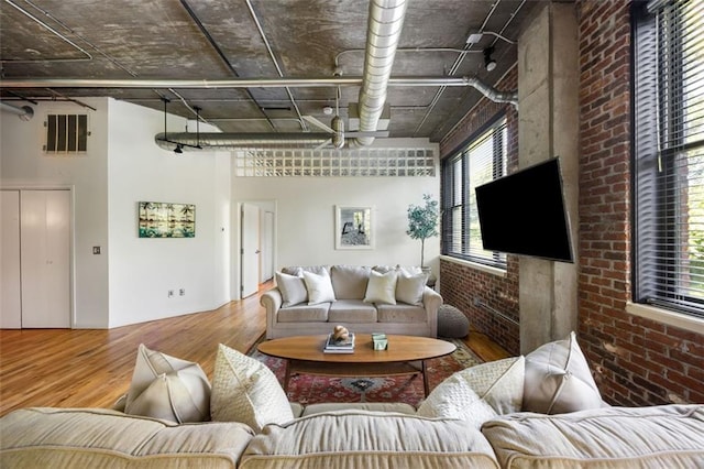 3235 Roswell Rd NE Unit 505, Atlanta, GA 30305 - living area with wood finished floors and brick wall