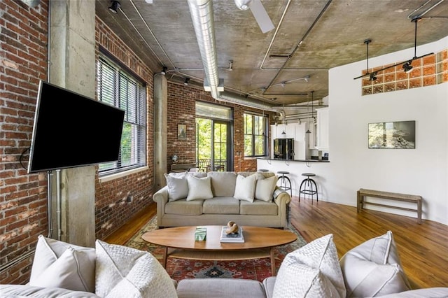 3235 Roswell Rd NE Unit 505, Atlanta, GA 30305 - living room featuring wood finished floors and brick wall