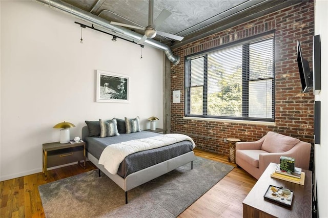 3235 Roswell Rd NE Unit 505, Atlanta, GA 30305 - bedroom with brick wall, wood finished floors, ceiling fan, and baseboards